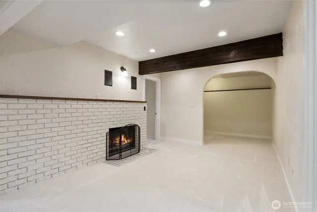 a view of an empty room with a fireplace