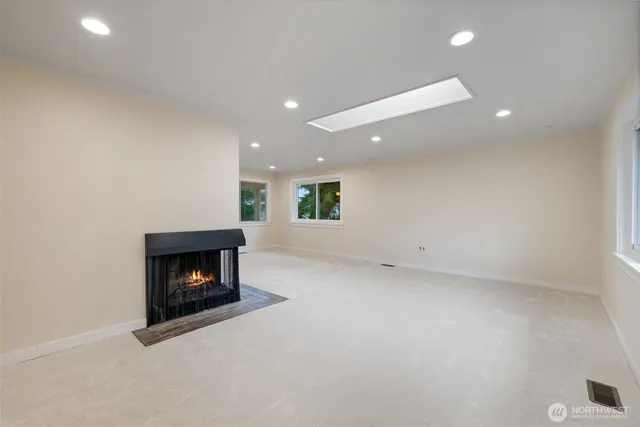 a view of an empty room with a fireplace
