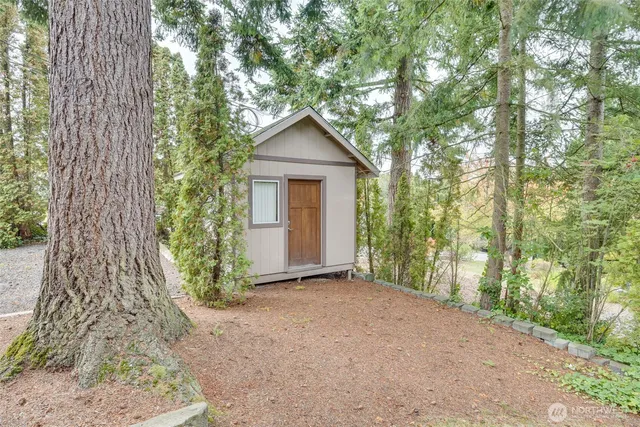 a view of a house with a tree in front of it
