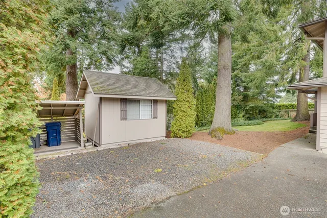 a front view of a house with a garden and yard