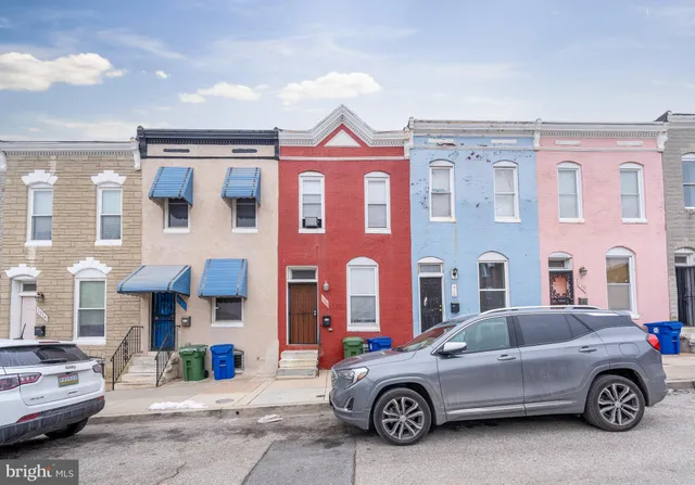 a car parked in front of a brick building
