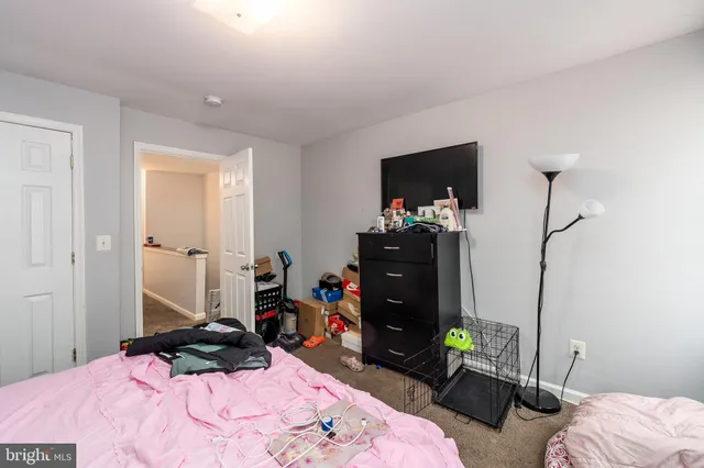 a bedroom with a bed and a television