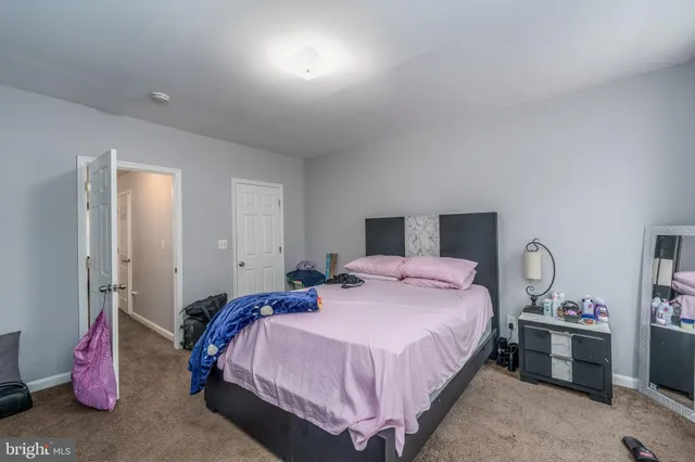 a bedroom with a bed and a potted plant