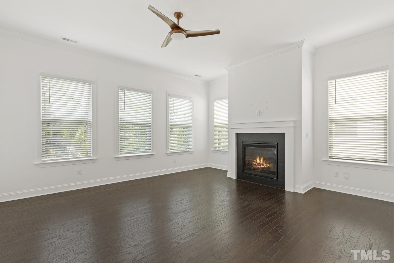 733 Midori Circle Cary, NC 27519 - Photo 12 of 41 a view of an empty room with wooden floor fireplace and a window