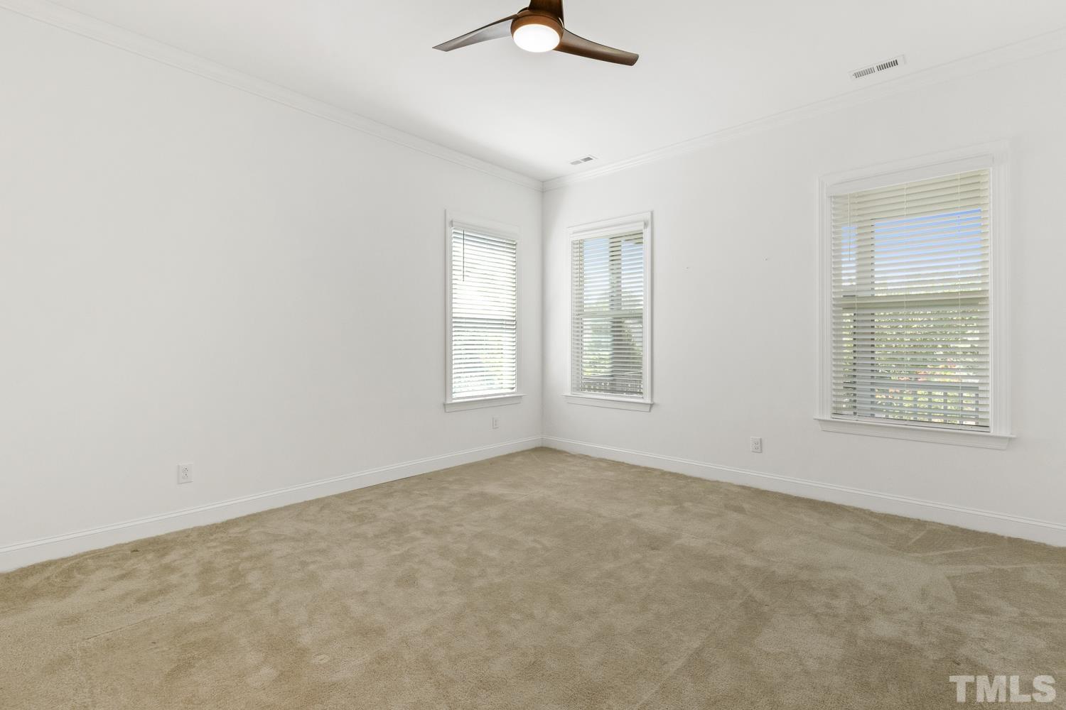 733 Midori Circle Cary, NC 27519 - Photo 20 of 41 an empty room with windows and fan