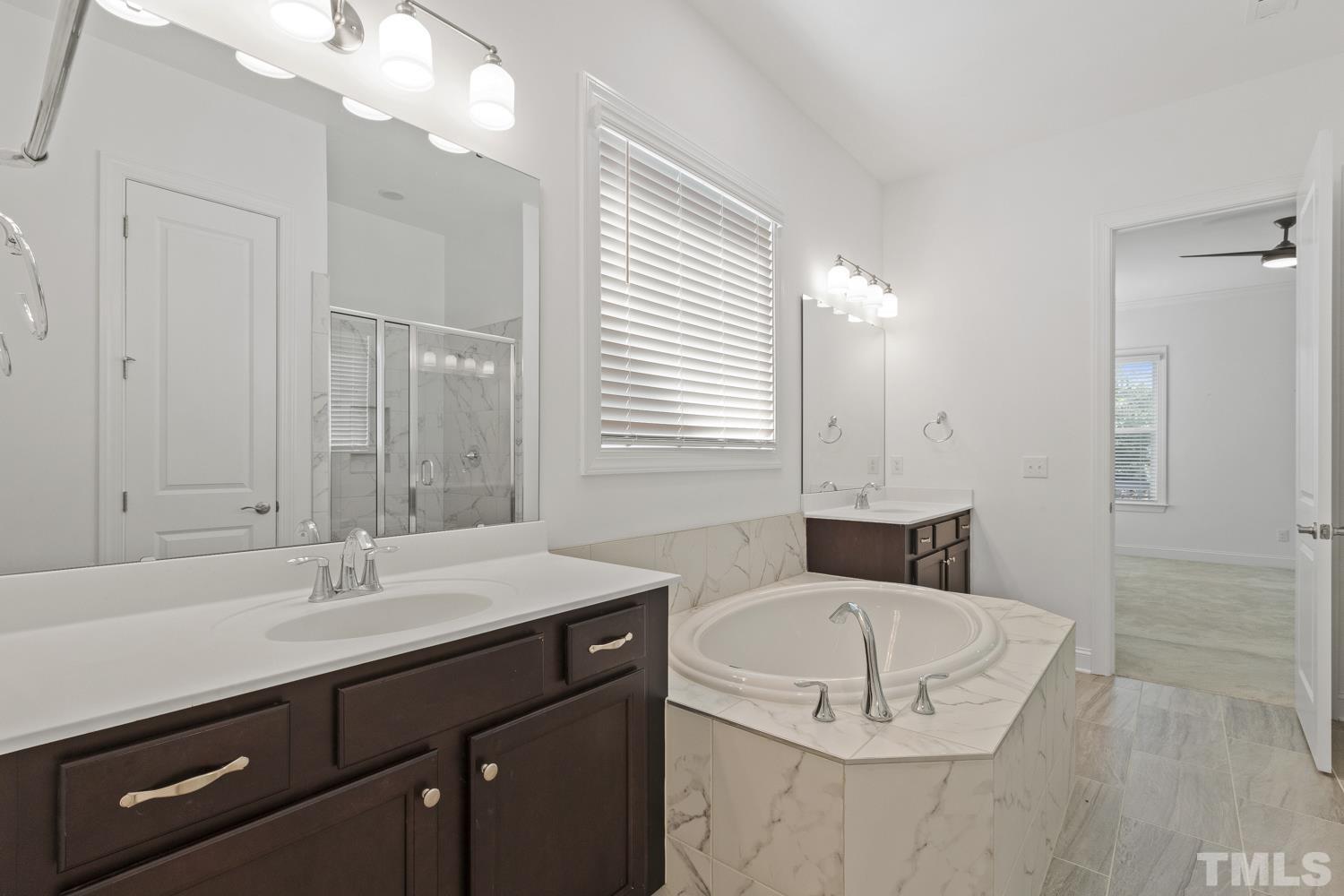 733 Midori Circle Cary, NC 27519 - Photo 24 of 41 a bathroom with a sink double vanity granite tub shower and a mirror
