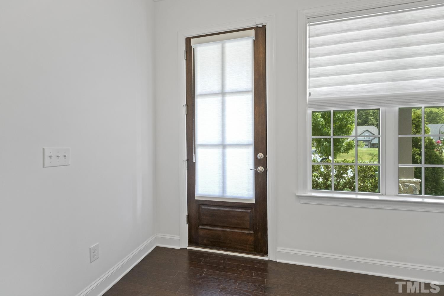 733 Midori Circle Cary, NC 27519 - Photo 3 of 41 a view of an empty room with wooden floor and windows