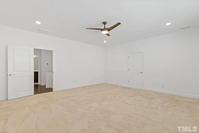 an empty room with closet and windows