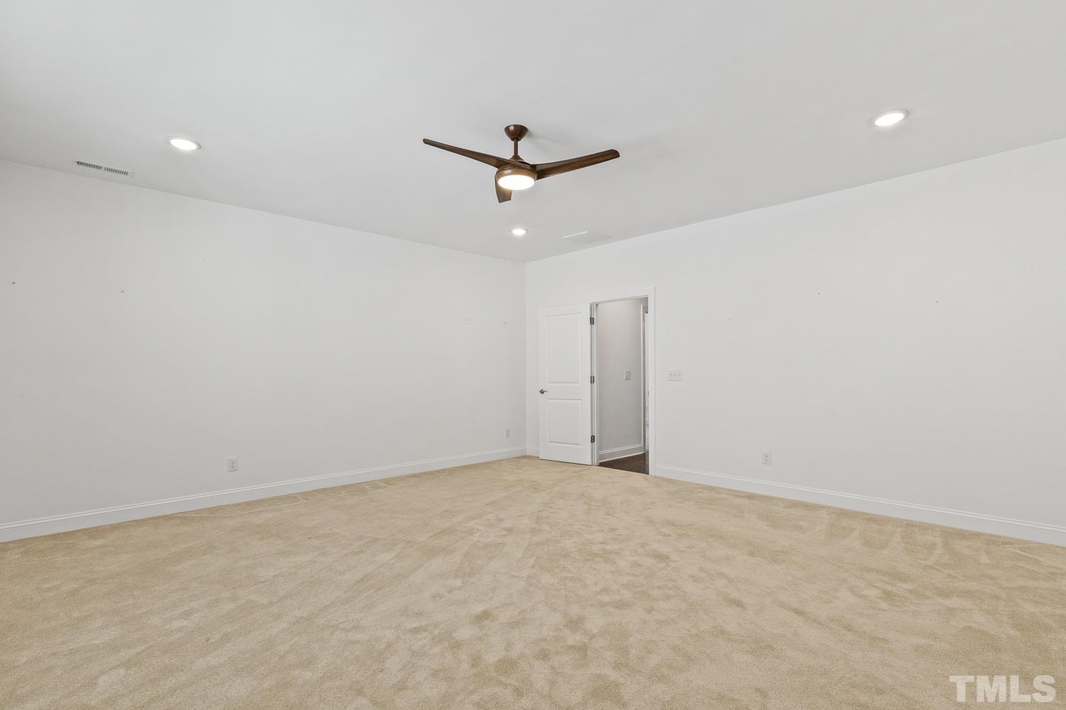 733 Midori Circle Cary, NC 27519 - Photo 32 of 41 an empty room with closet and a ceiling fan
