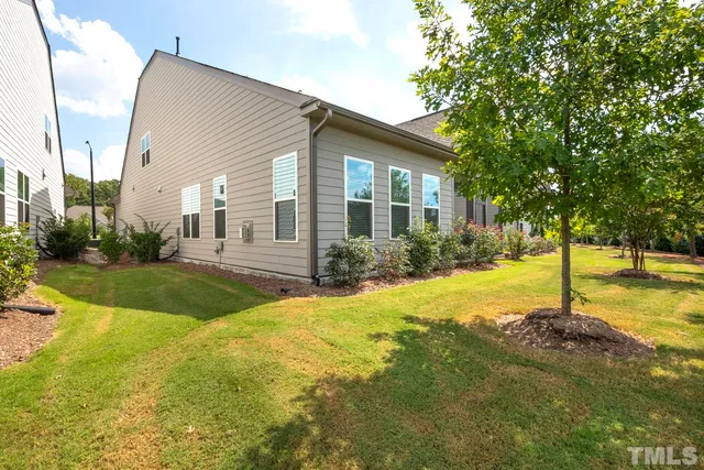 a view of a house with swimming pool and yard