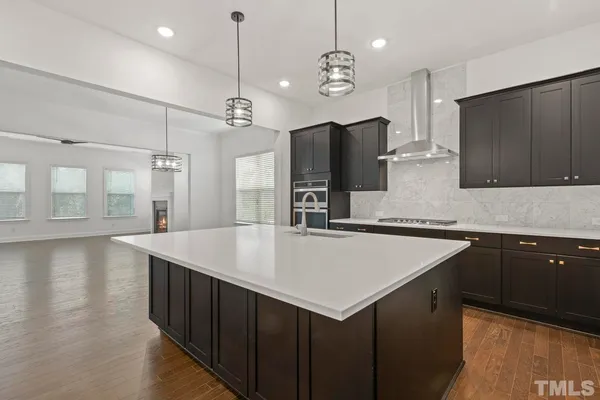 a kitchen with a center island a counter space cabinets and stainless steel appliances