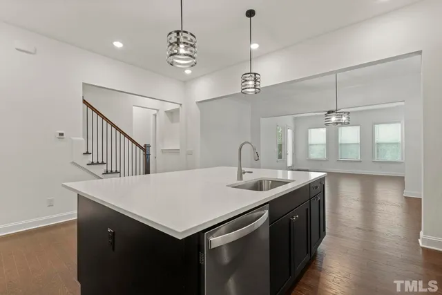 a kitchen with sink cabinets and wooden floor