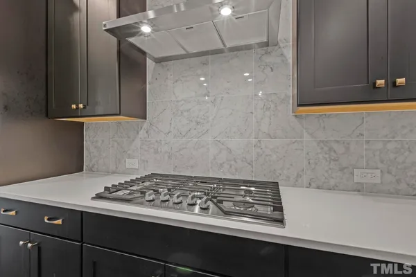 a stove top oven sitting inside of a kitchen