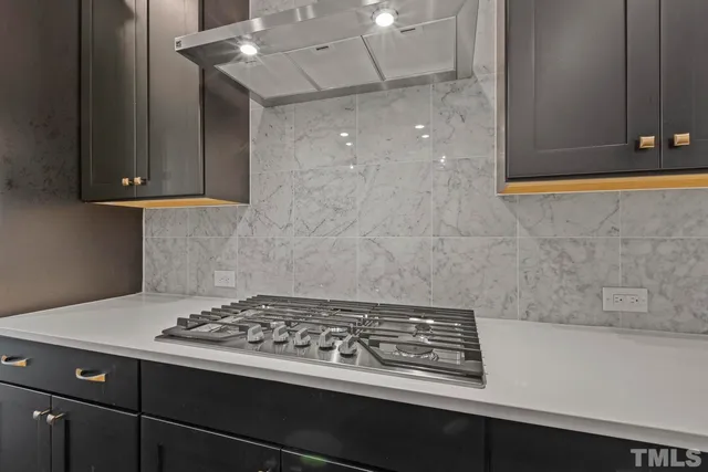 a stove top oven sitting inside of a kitchen