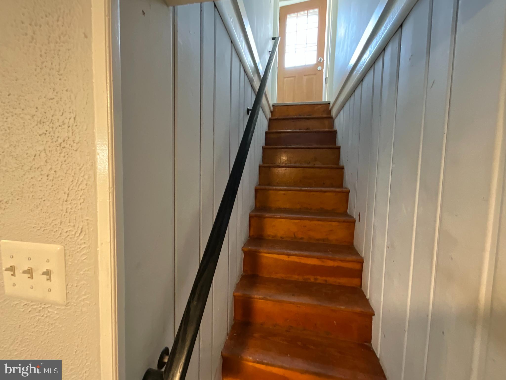 10405 Georgia Avenue Silver Spring, MD 20902 - Photo 12 of 16 a view of staircase with wooden floor and white walls