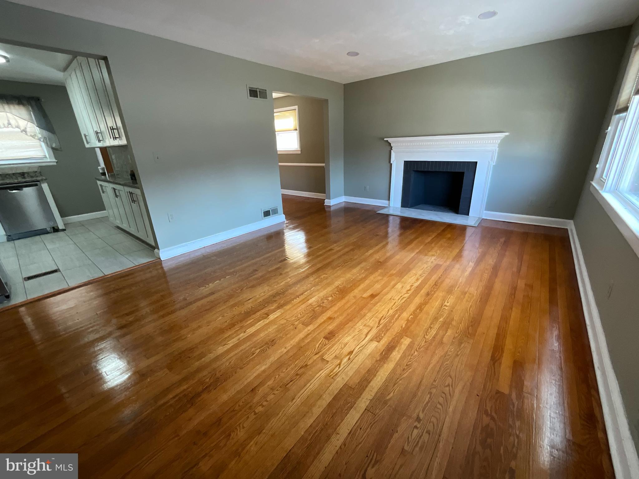 10405 Georgia Avenue Silver Spring, MD 20902 - Photo 4 of 16 a view of empty room with wooden floor and fireplace