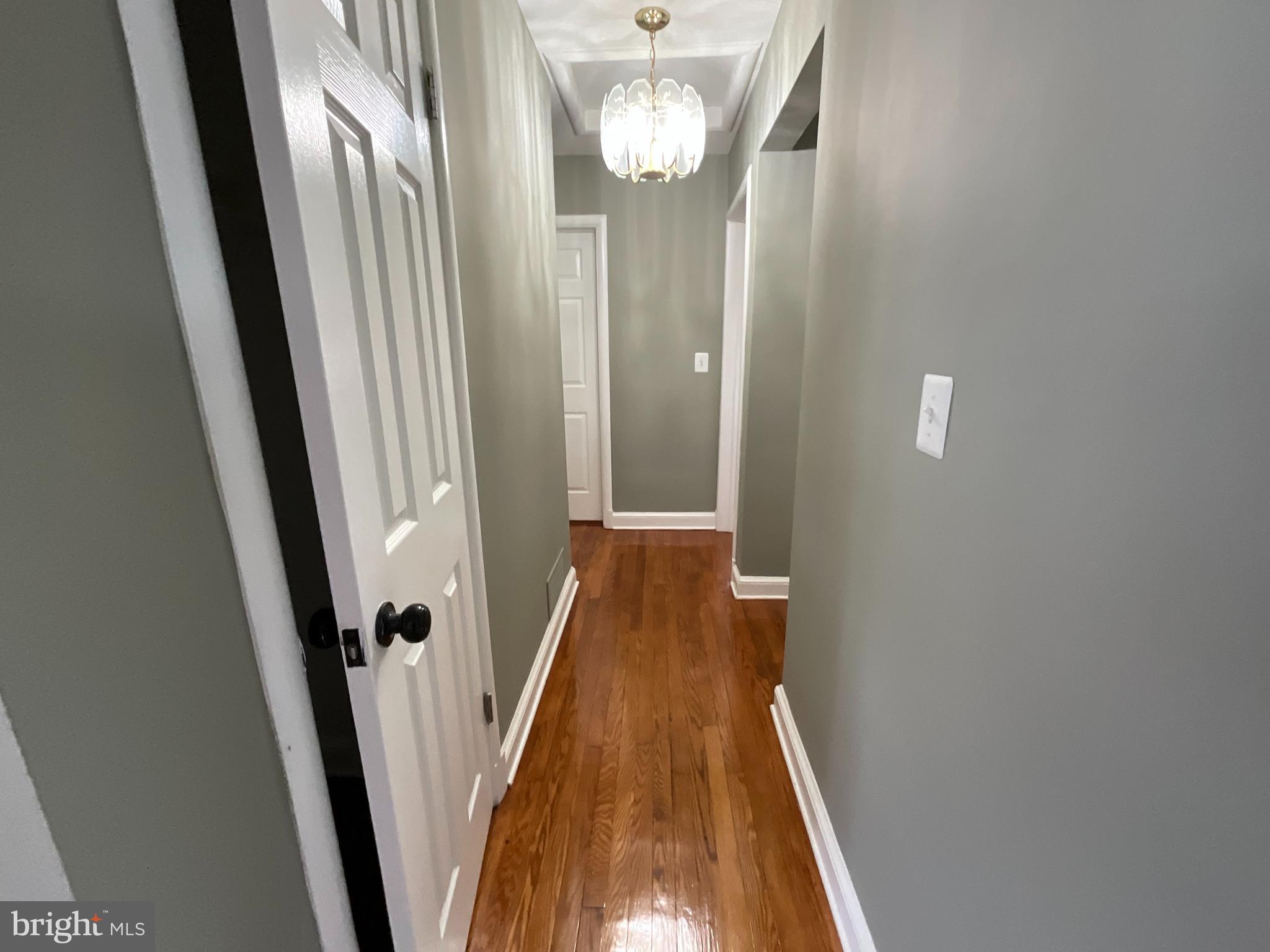 10405 Georgia Avenue Silver Spring, MD 20902 - Photo 7 of 16 a view of a hallway with wooden floor and stairs