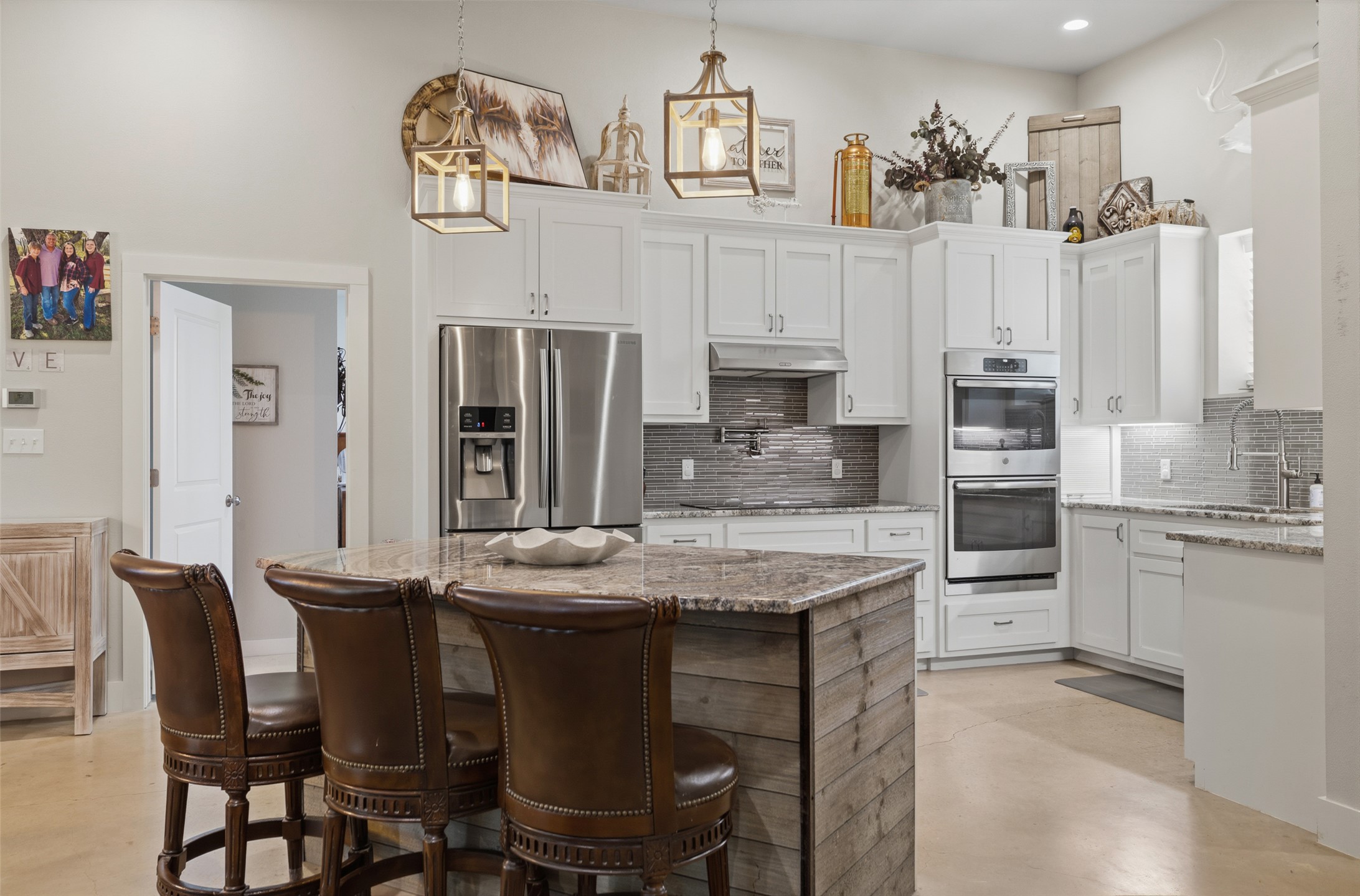 764 Stubbs Road Johnson City, TX 78636 - Photo 2 of 29 A well-appointed kitchen features a central island, recessed lighting, and elegant pendant fixtures.