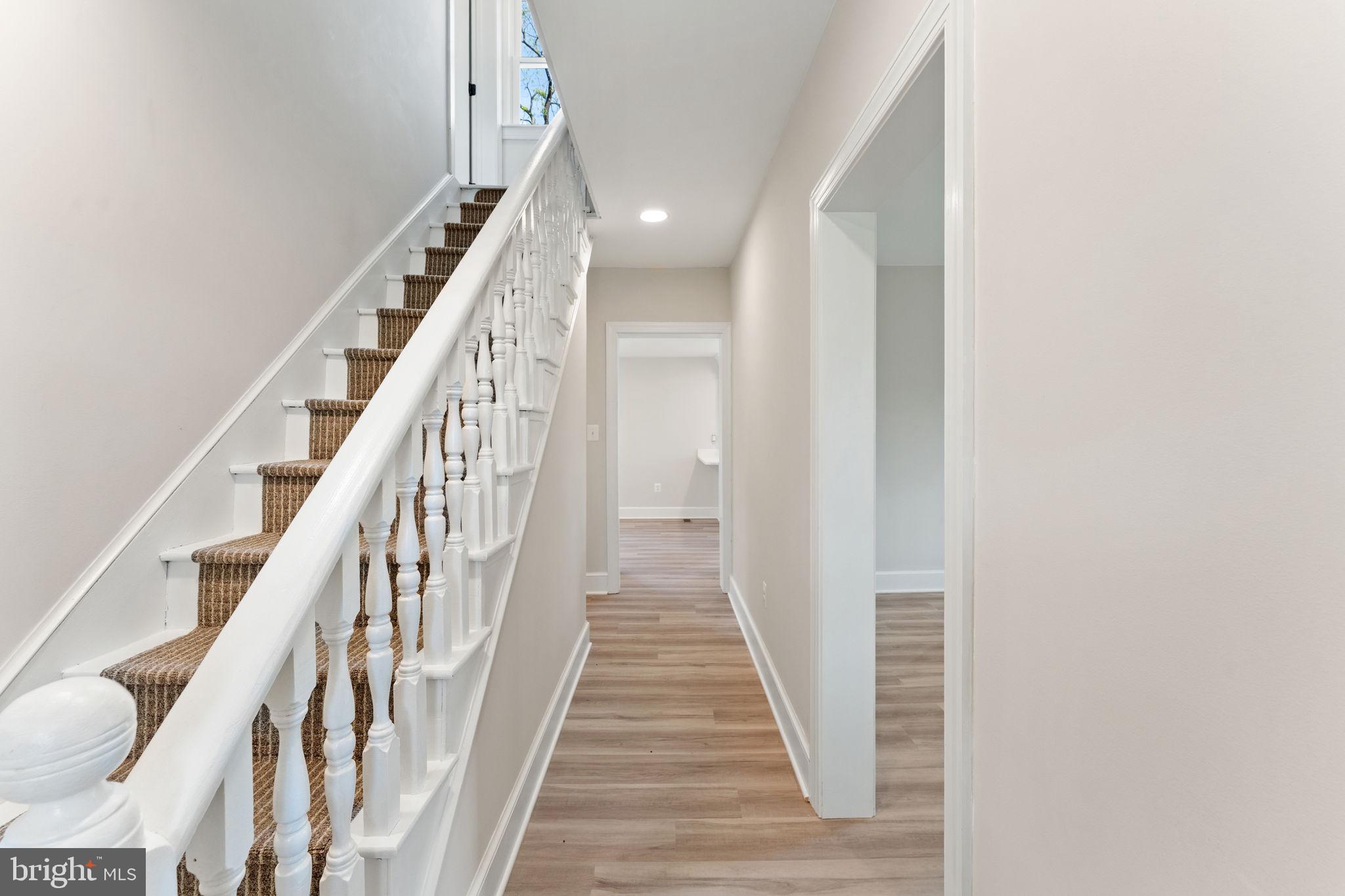 11066 Moreland Road Delaplane, VA 20144 - Photo 13 of 87 a view of a hallway with wooden floor and staircase