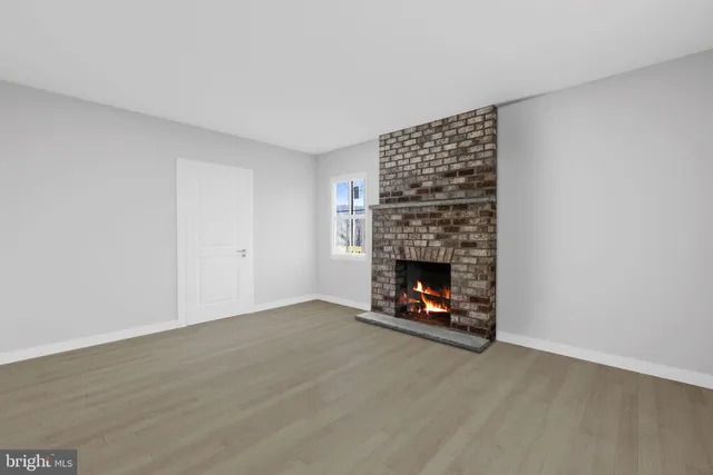 a view of an empty room with fire place