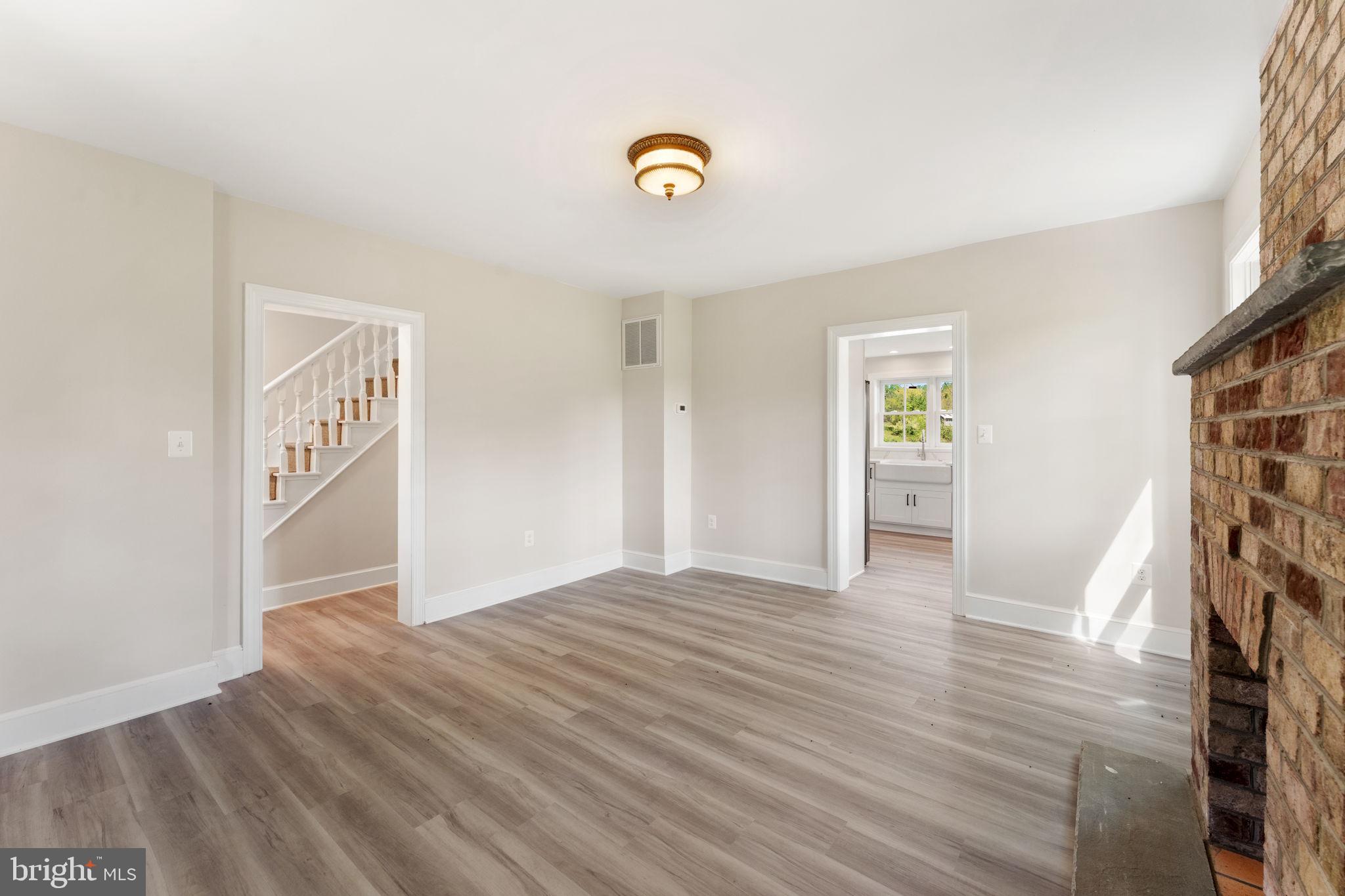 11066 Moreland Road Delaplane, VA 20144 - Photo 20 of 87 a view of an empty room with window and wooden floor