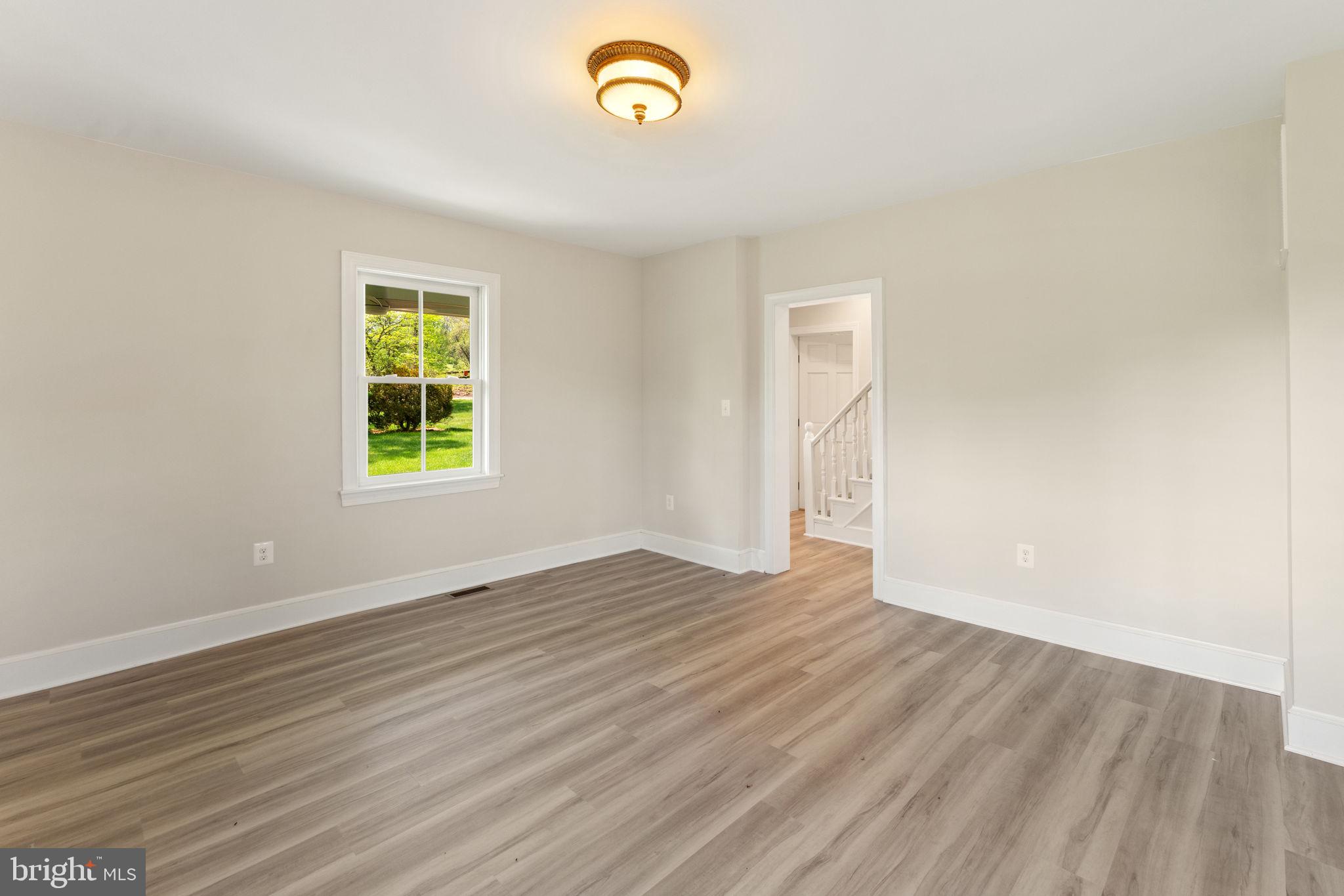 11066 Moreland Road Delaplane, VA 20144 - Photo 22 of 87 an empty room with wooden floor and a window