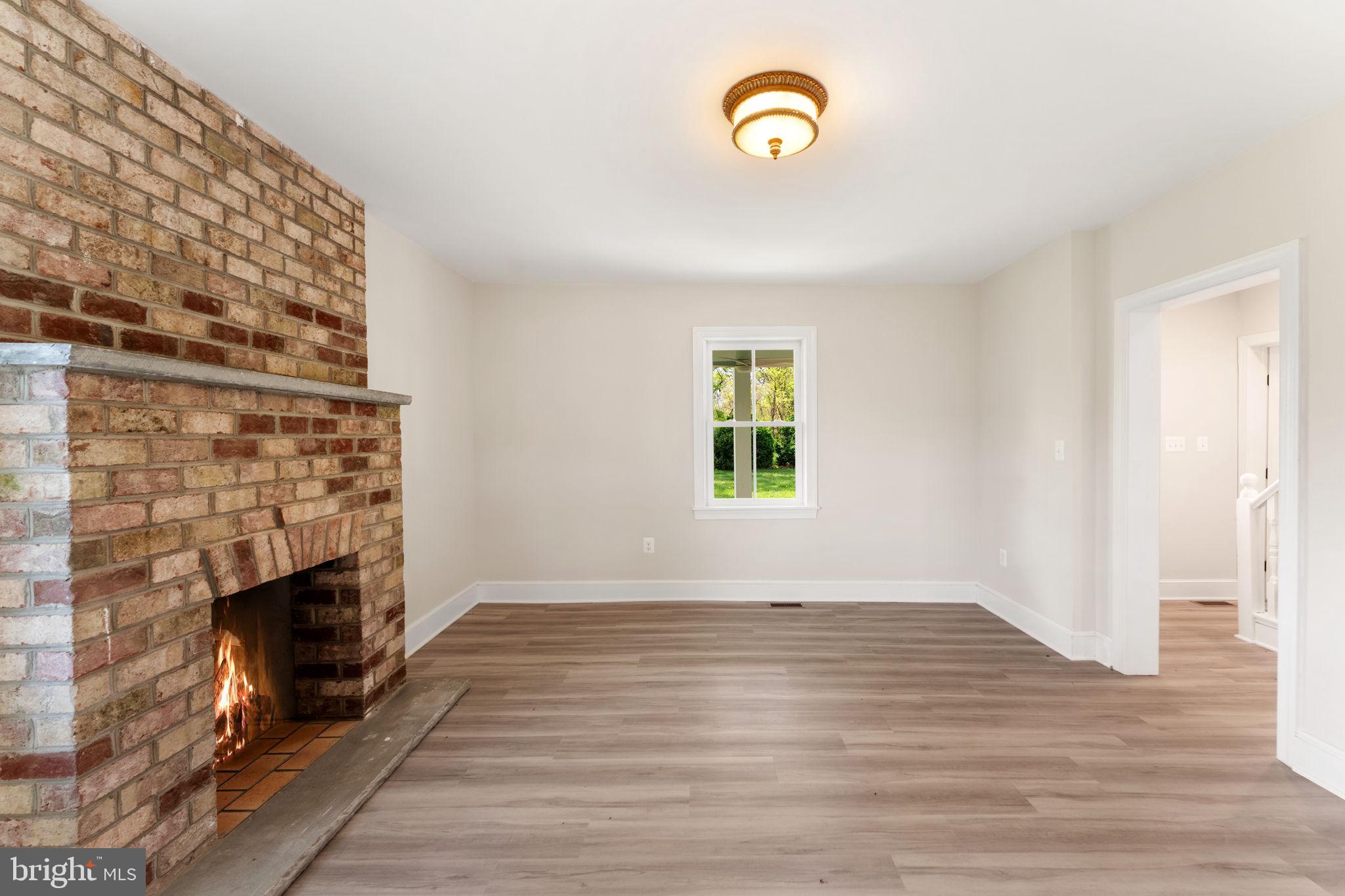 11066 Moreland Road Delaplane, VA 20144 - Photo 23 of 87 a view of an empty room with a fireplace and a window