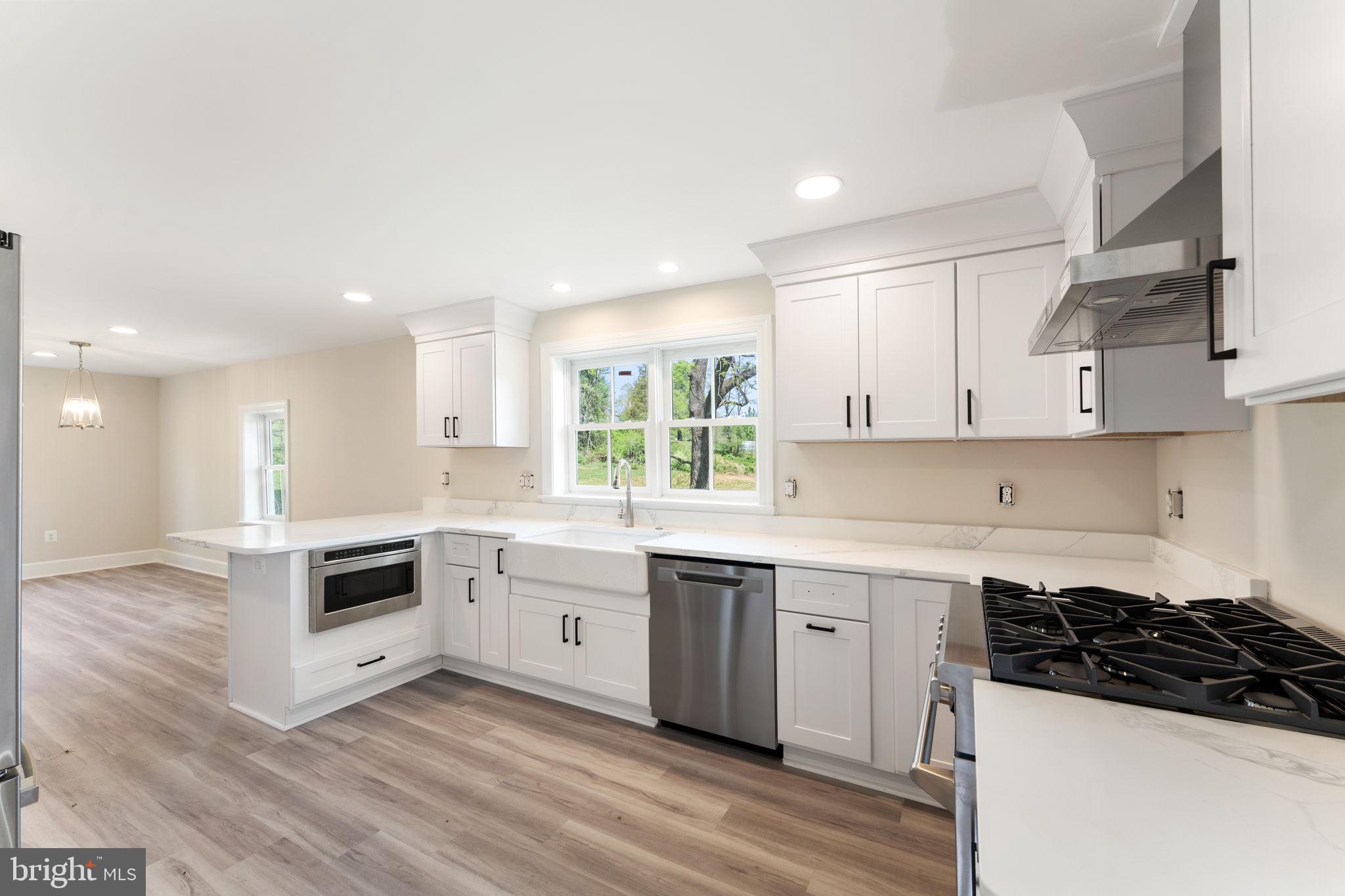 11066 Moreland Road Delaplane, VA 20144 - Photo 25 of 87 a kitchen with granite countertop white cabinets and appliances