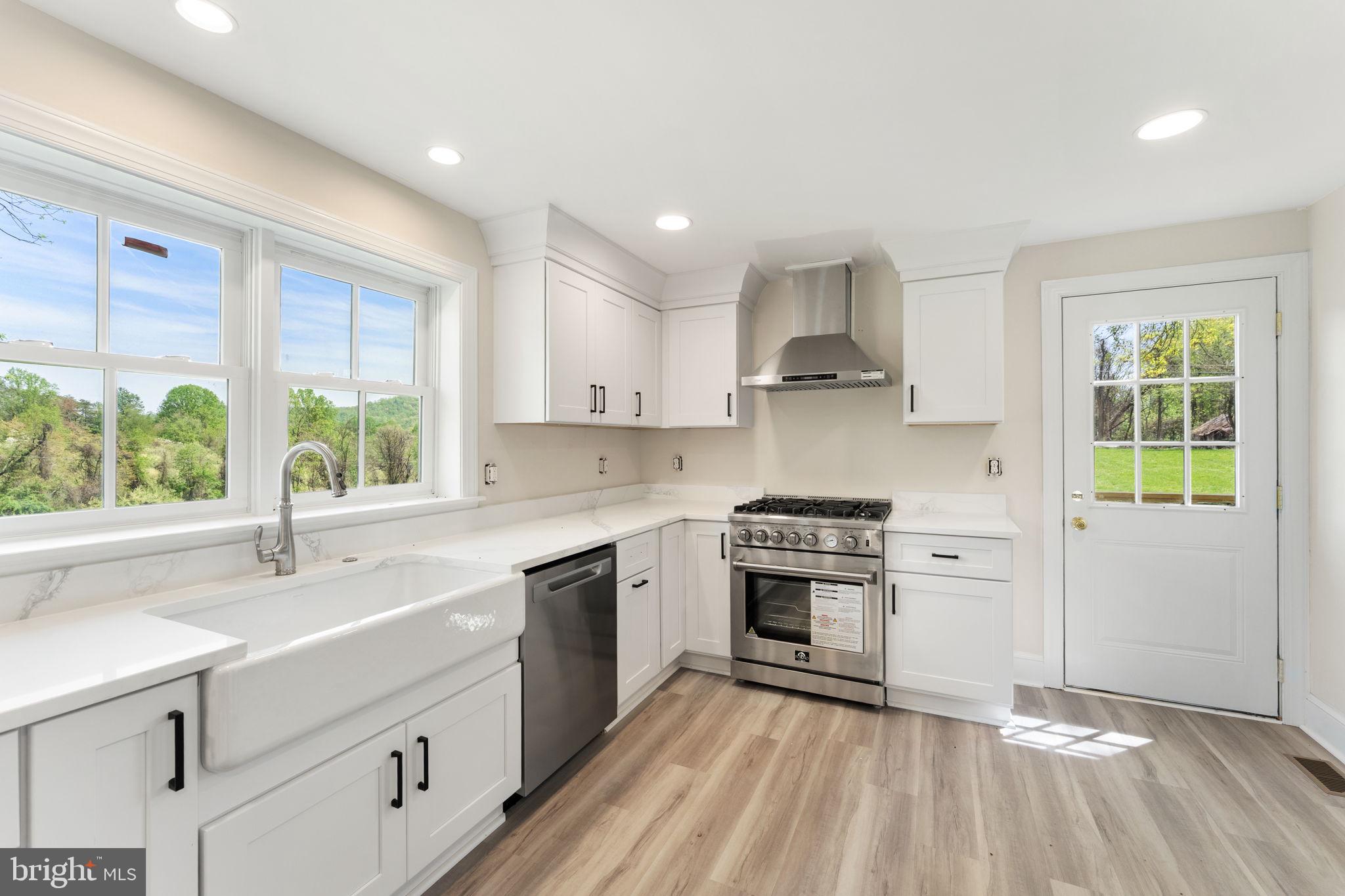 11066 Moreland Road Delaplane, VA 20144 - Photo 30 of 87 a kitchen with a stove a sink and a refrigerator