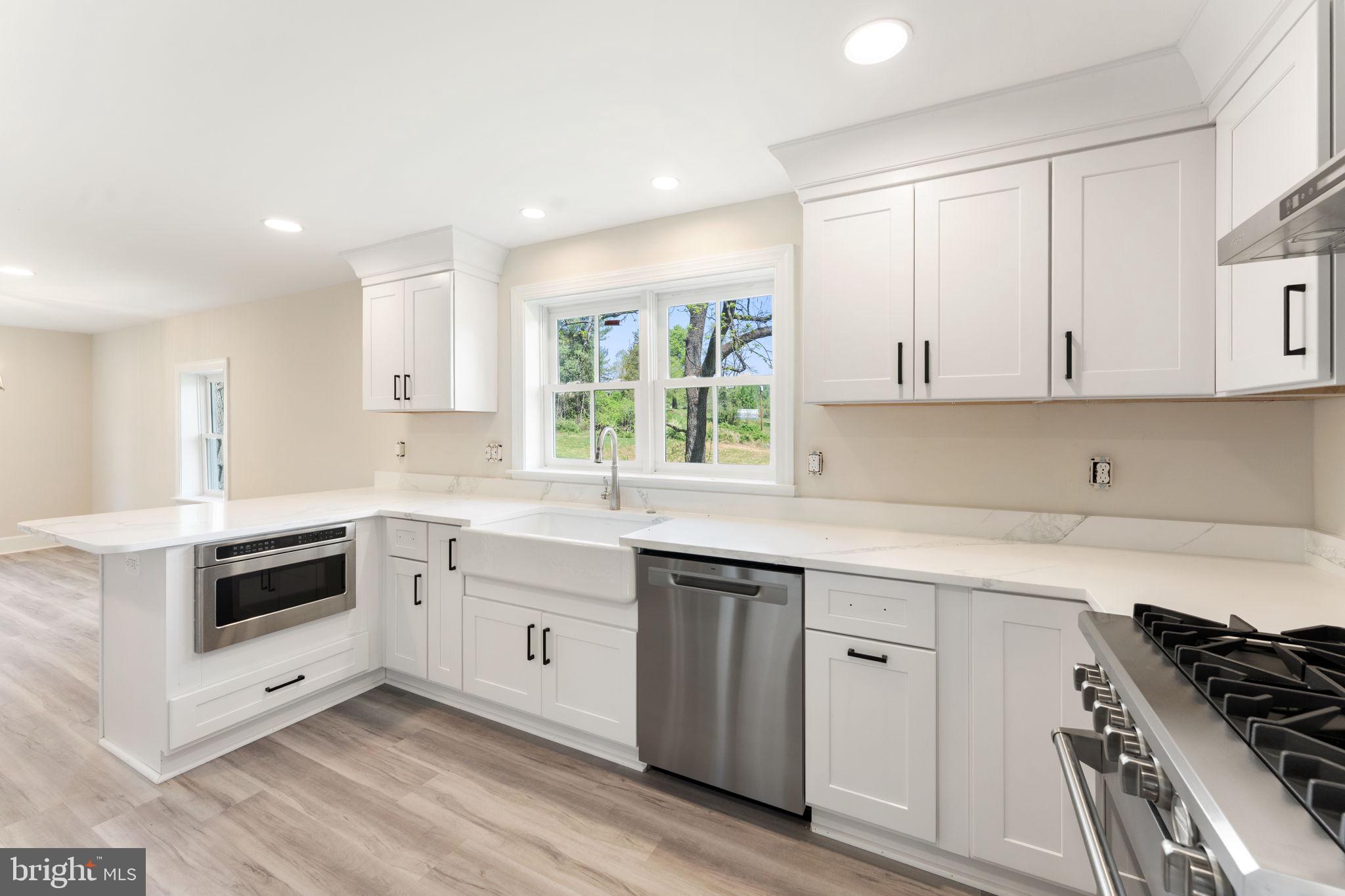 11066 Moreland Road Delaplane, VA 20144 - Photo 32 of 87 a kitchen with granite countertop white cabinets and white appliances