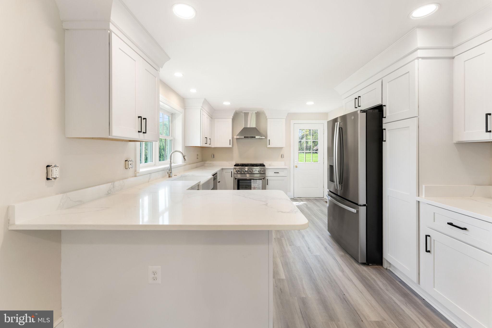 11066 Moreland Road Delaplane, VA 20144 - Photo 37 of 87 a kitchen with stainless steel appliances granite countertop a refrigerator sink and white cabinets