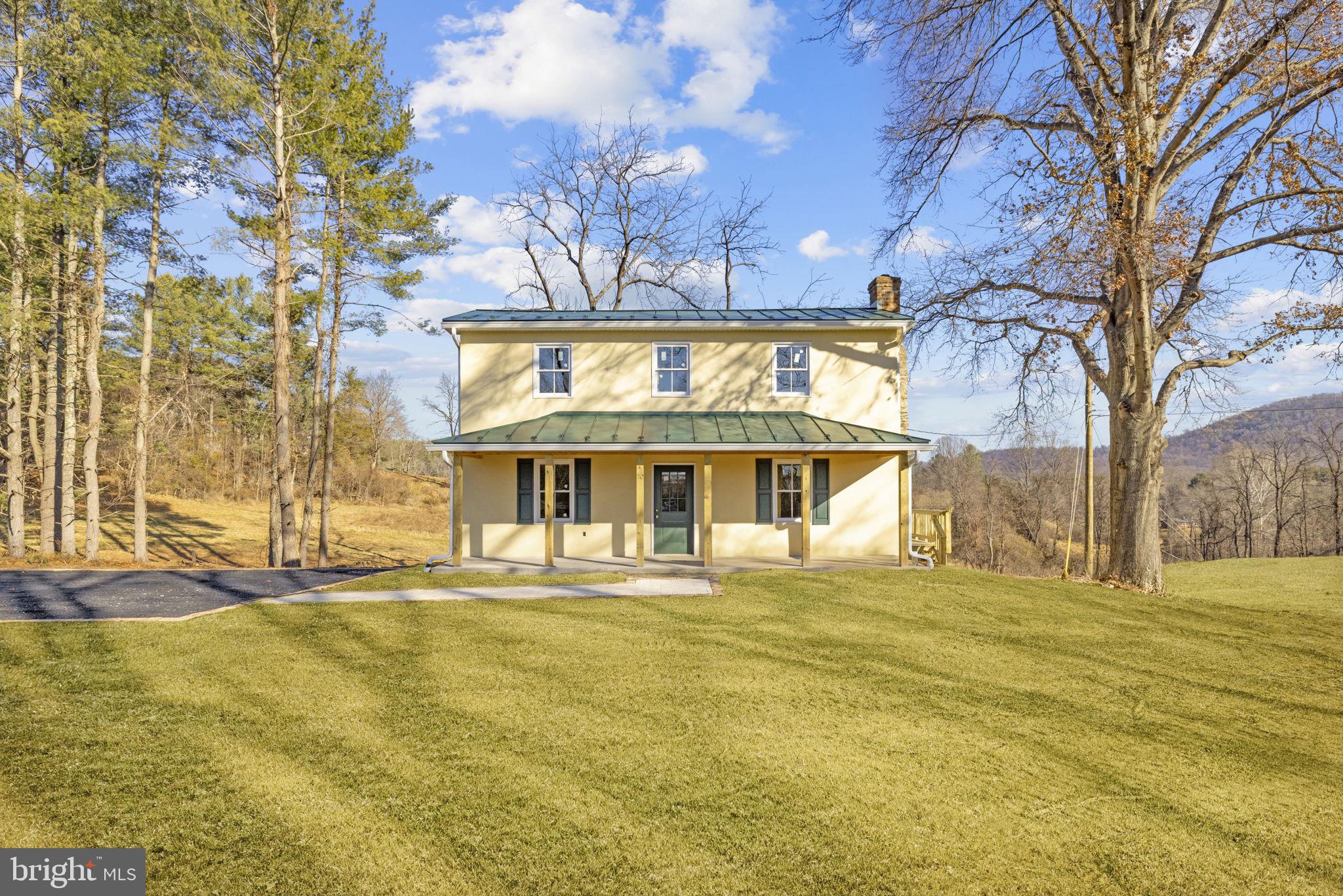 11066 Moreland Road Delaplane, VA 20144 - Photo 5 of 37 a view of a large building with a large trees