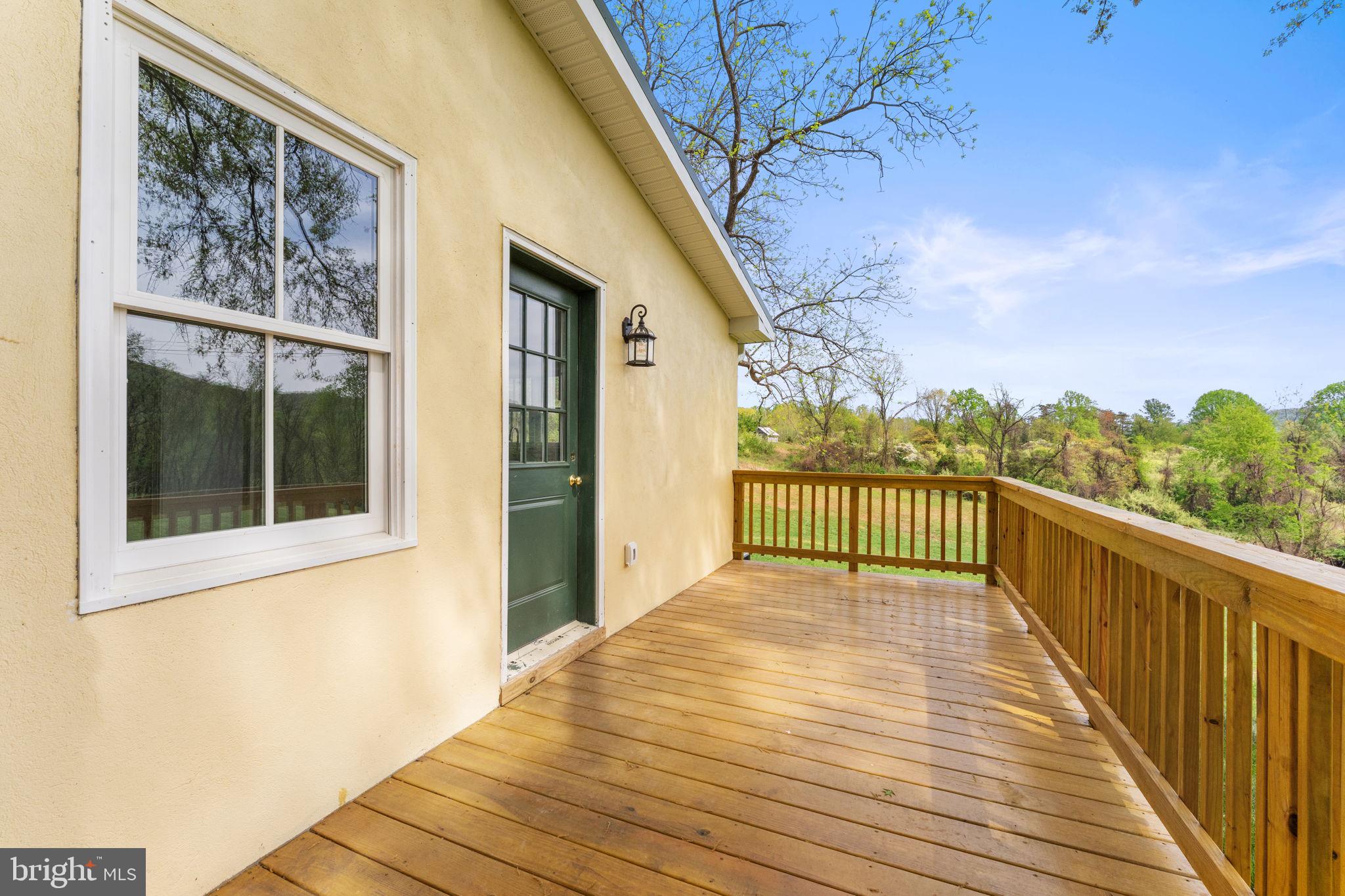 11066 Moreland Road Delaplane, VA 20144 - Photo 66 of 87 a view of a balcony with wooden floor and fence