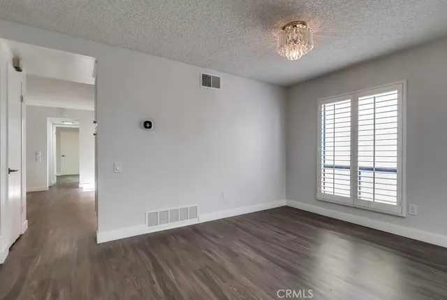 a view of a kitchen with wooden floor and electronic appliances