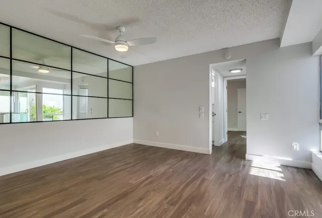 a view of kitchen view wooden floor and stainless steel appliances