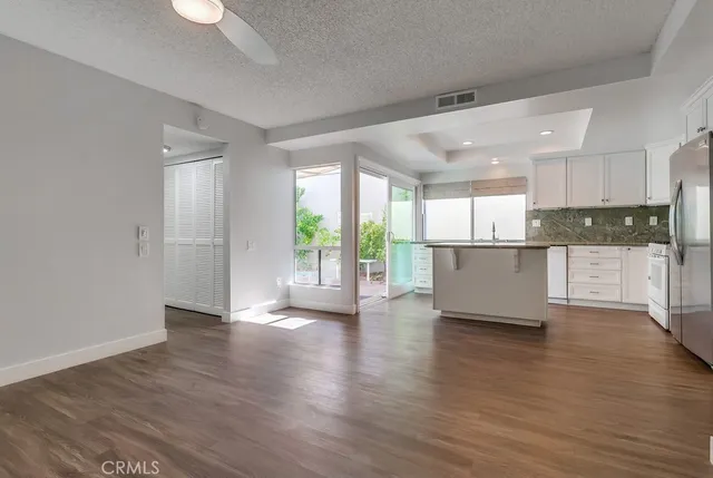 a kitchen with stainless steel appliances a refrigerator sink and cabinets
