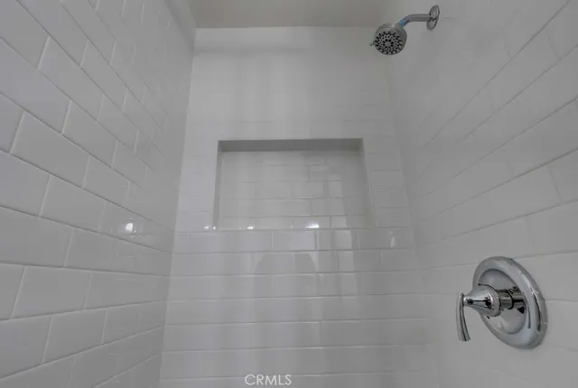 a bathroom with a shower a toilet and sink