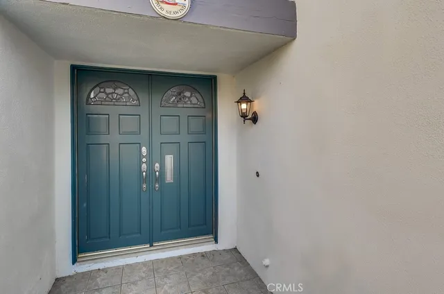 an empty room with wooden floor fireplace and windows