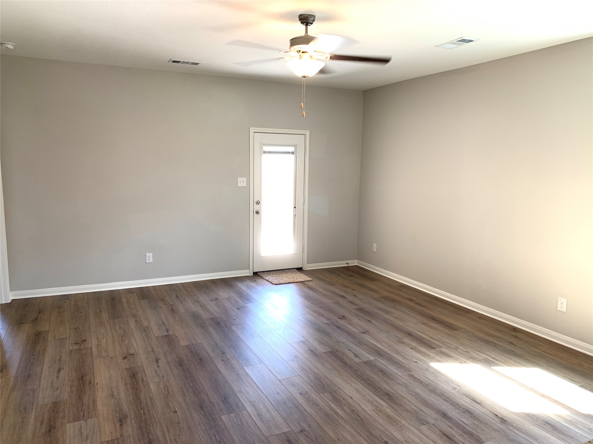112 Declaration Lane Liberty Hill, TX 78642 - Photo 3 of 15 a view of an empty room with wooden floor and a window