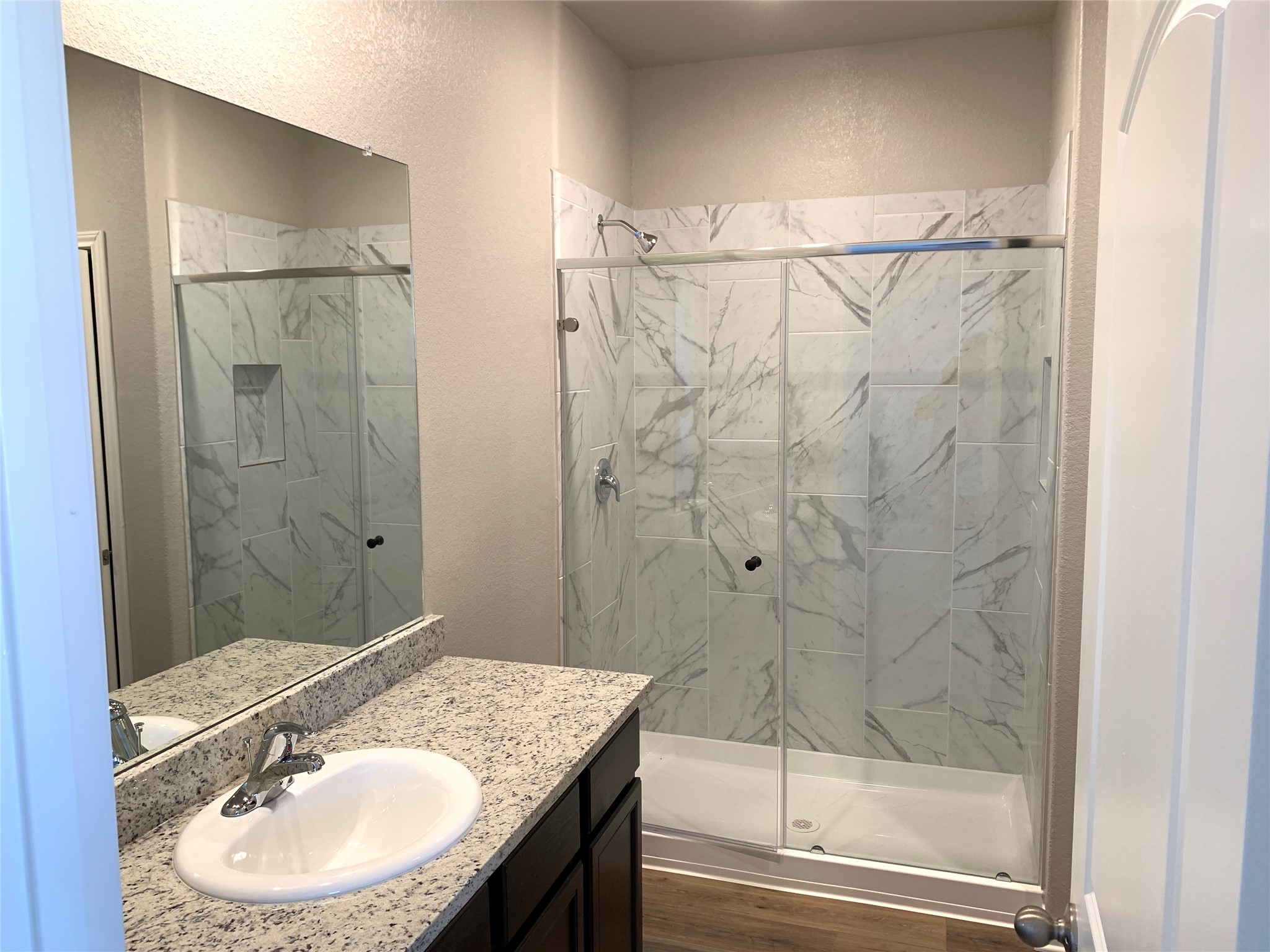 112 Declaration Lane Liberty Hill, TX 78642 - Photo 8 of 15 a bathroom with a granite countertop shower sink vanity mirror and a bathtub