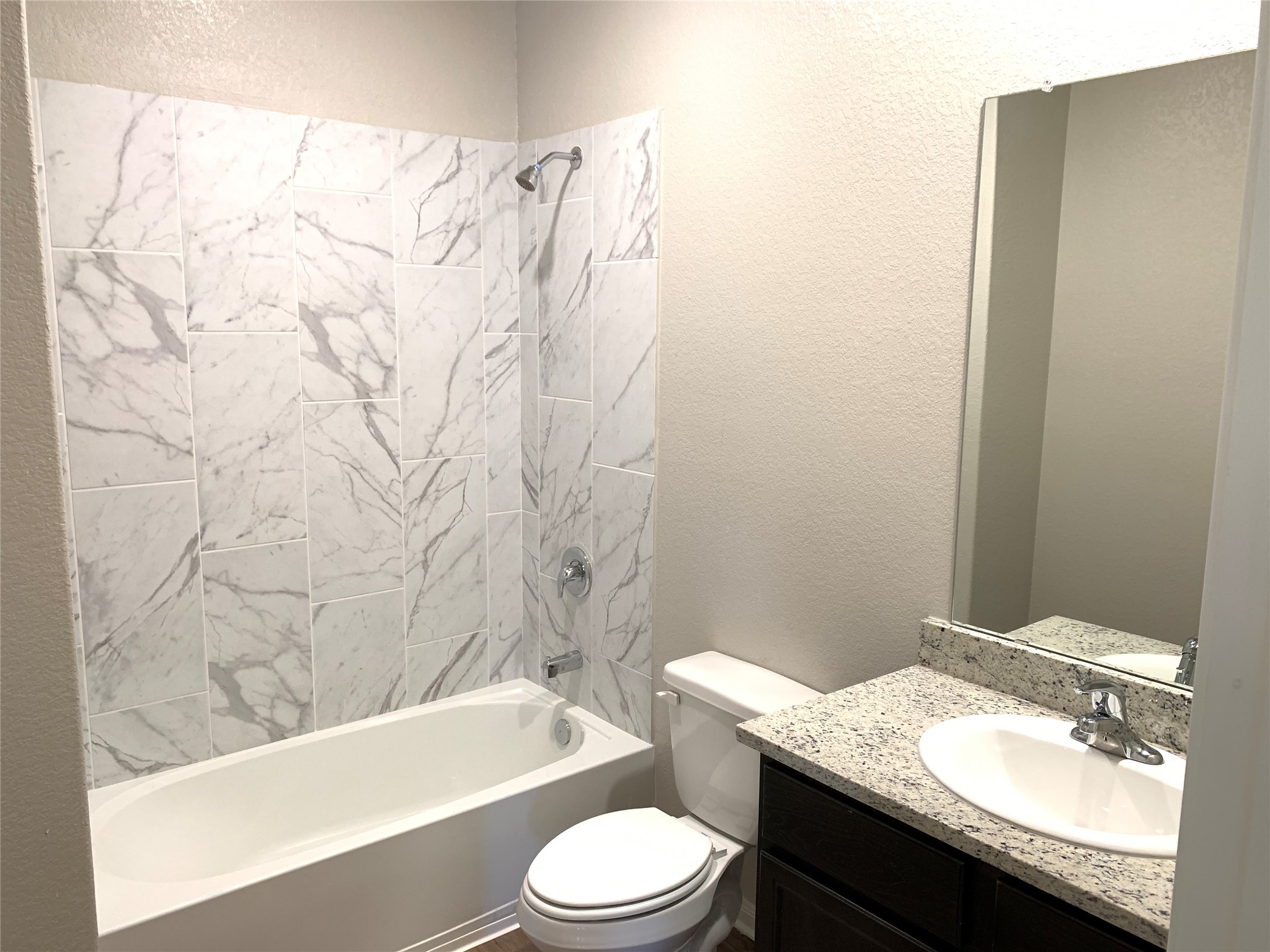 112 Declaration Lane Liberty Hill, TX 78642 - Photo 10 of 15 a bathroom with a granite countertop bathtub sink vanity mirror and toilet