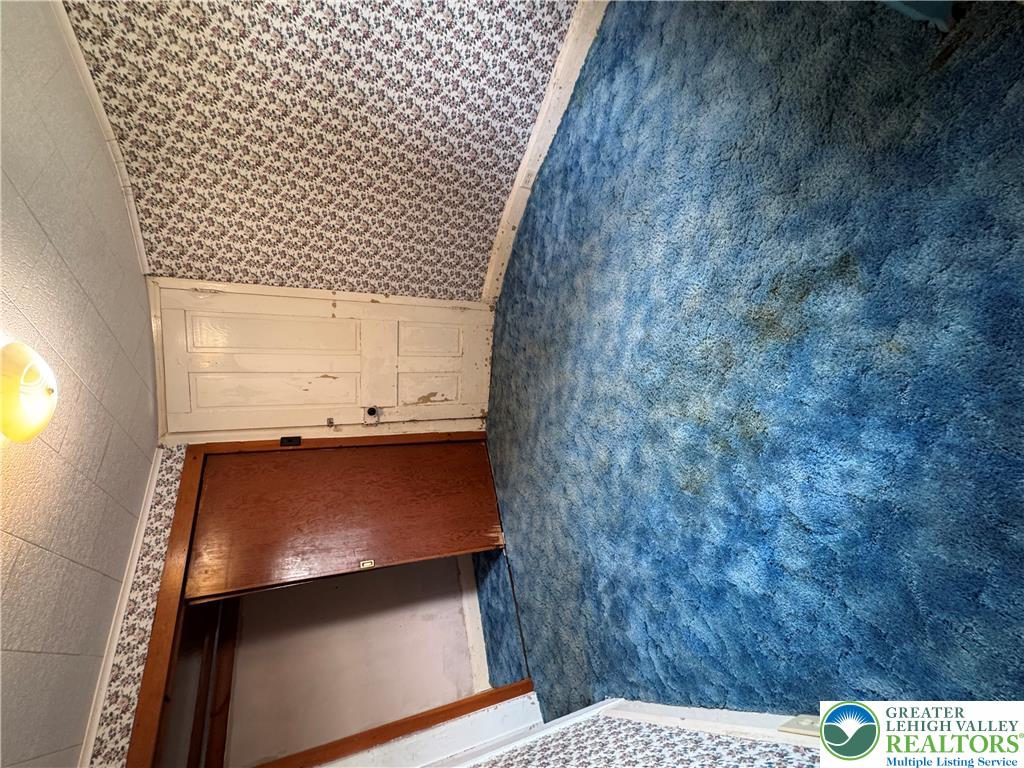 868 Catawissa Road Tamaqua, PA 18252 - Photo 33 of 67 A charming bedroom with a distinctively textured blue carpet offers a cozy retreat.
