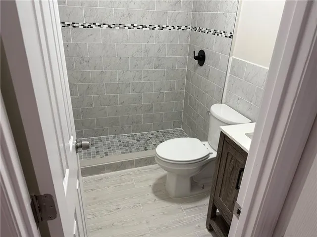 a bathroom with a toilet and a shower