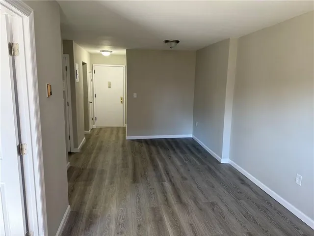 a view of a room with wooden floor