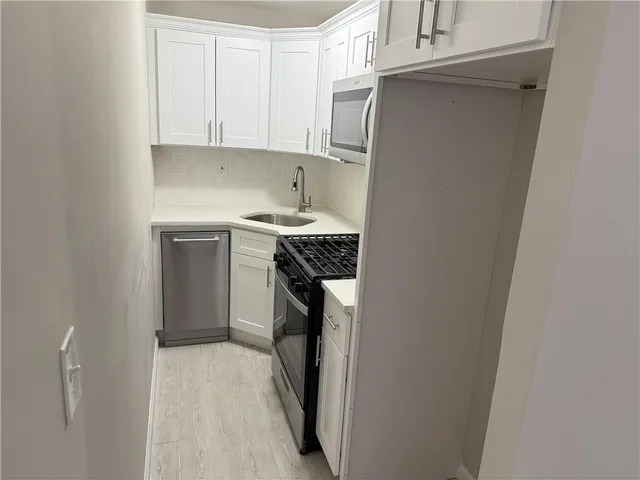 a kitchen with a sink and a refrigerator