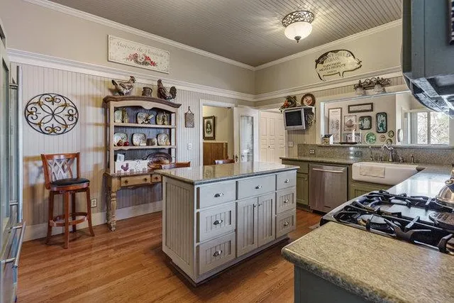a kitchen with stainless steel appliances granite countertop a stove and cabinets