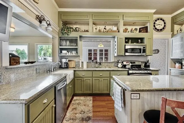 a kitchen with stainless steel appliances granite countertop a sink and cabinets