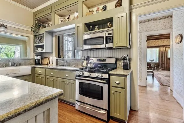 a kitchen with stainless steel appliances granite countertop a stove and a sink