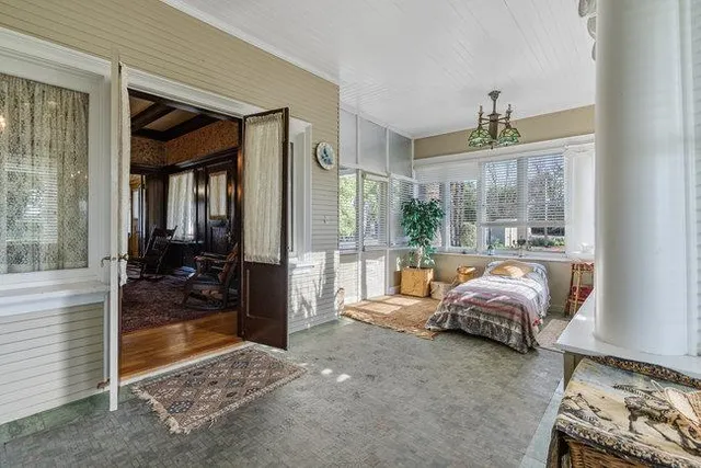 a living room with furniture and a floor to ceiling window