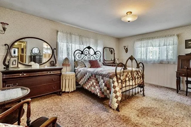 a bedroom with bed and a dresser